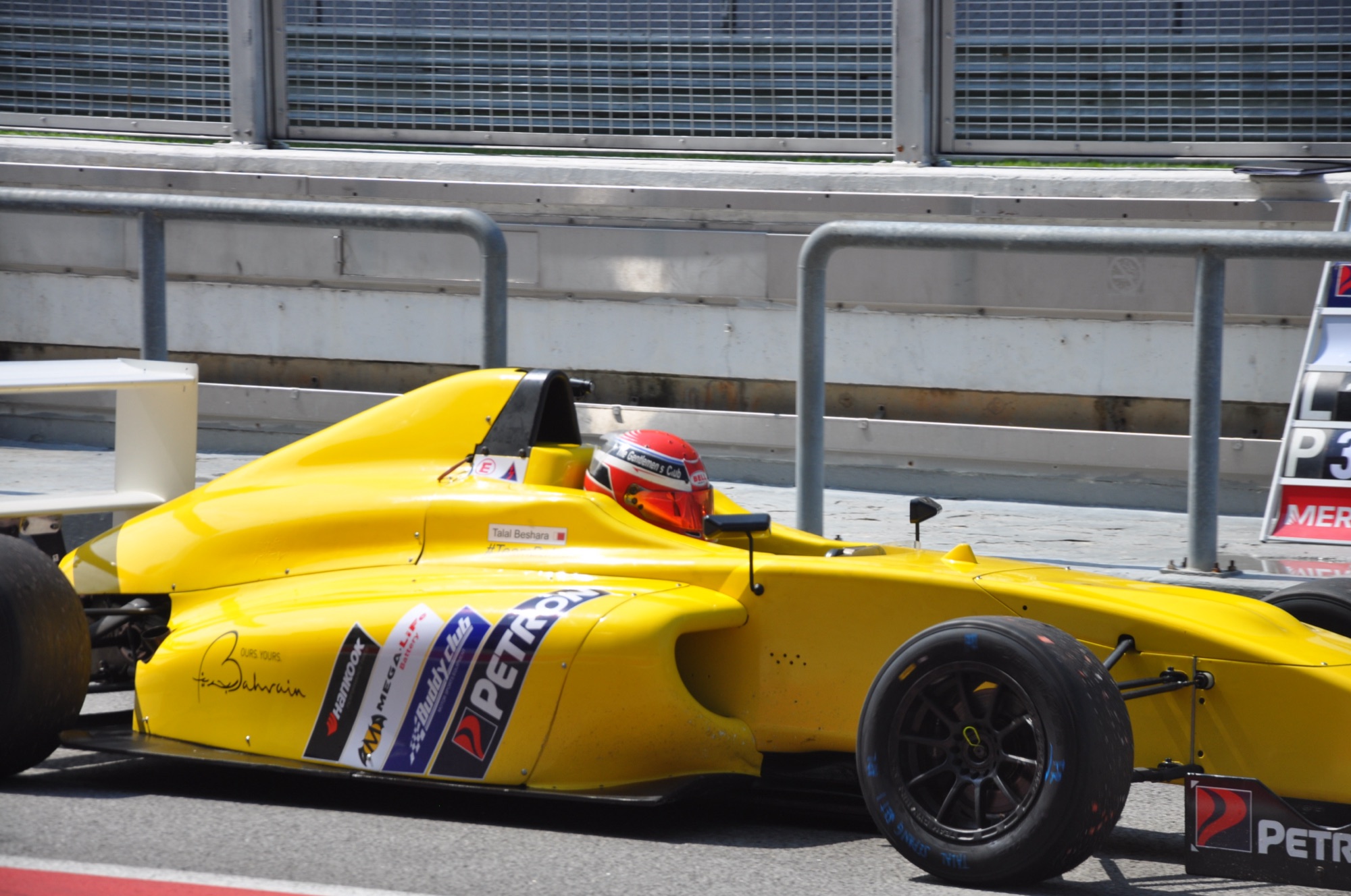 Talal Beshara in the yellow Formula 4 car in pit lane
