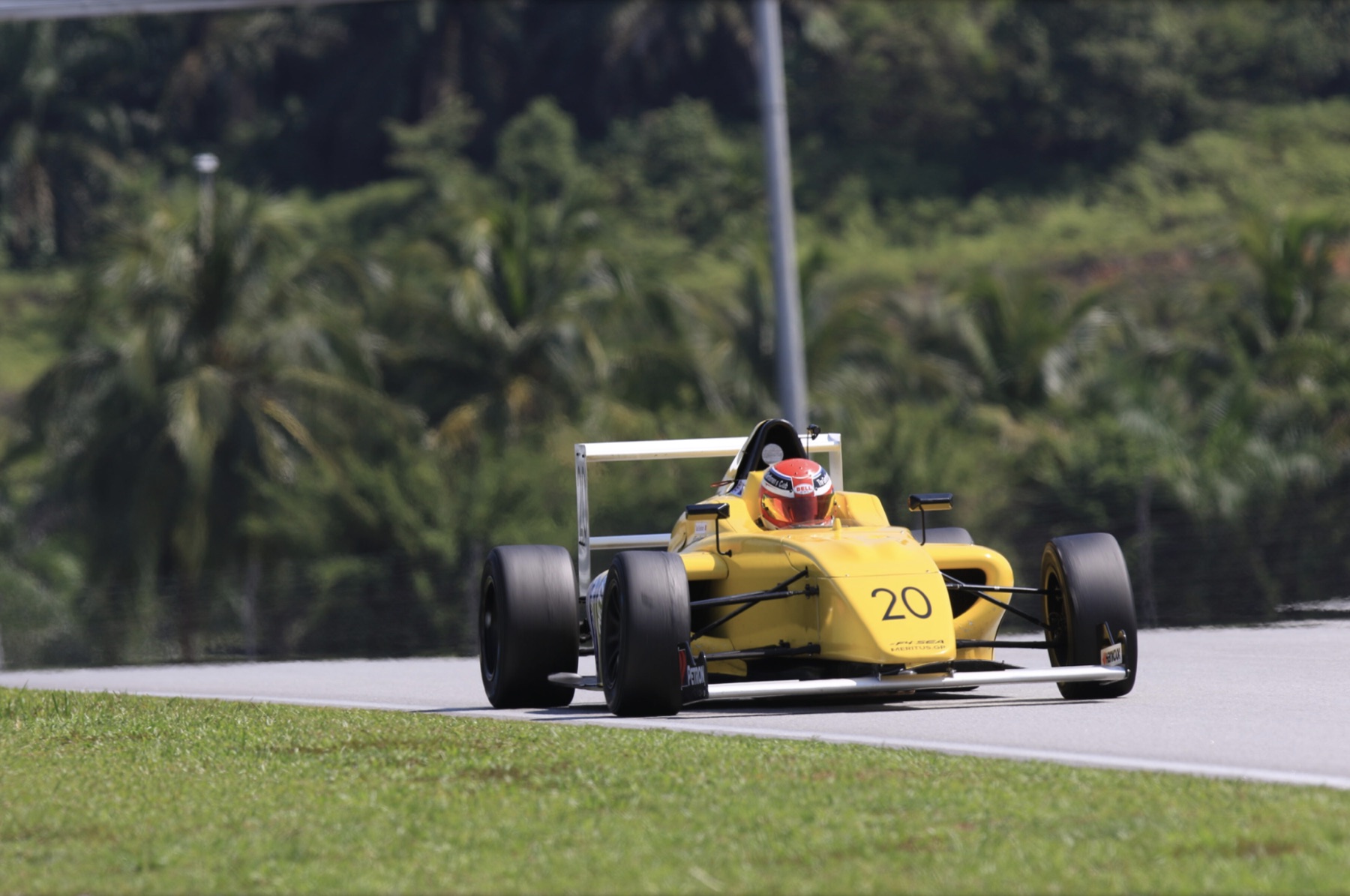 Yellow #20 Formula 4 car head-on at Sepang